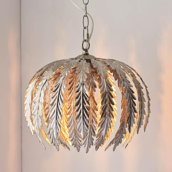 The Endon Delphine 1 Light Globe Pendant Ceiling Light showcases a stunning silver leaf effect with a modern spherical design. This dimmable and height-adjustable fixture brings sophistication and warmth to any space, making it a perfect choice for luxurious and contemporary interiors.