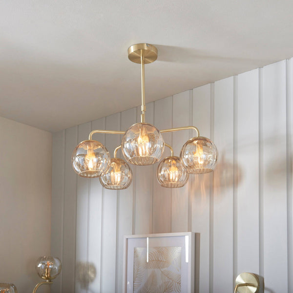 Endon Dimple 5-Light Rectangular Pendant Light in Brass features champagne lustre glass shades, a satin brushed gold finish, and an adjustable drop, making it a refined and stylish addition to contemporary interiors.