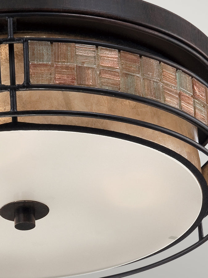 Elstead Laguna is a range that features a mosaic tile stripe, which appears to be floating around a taupe mica shade. The tiles have a coppery shimmer for an added touch of elegance. It provides a warm and inviting accent for most homes.
