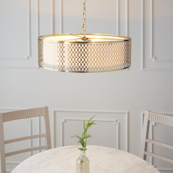 Cordero 3 Light Pendant in gold fretwork shown in a room setting