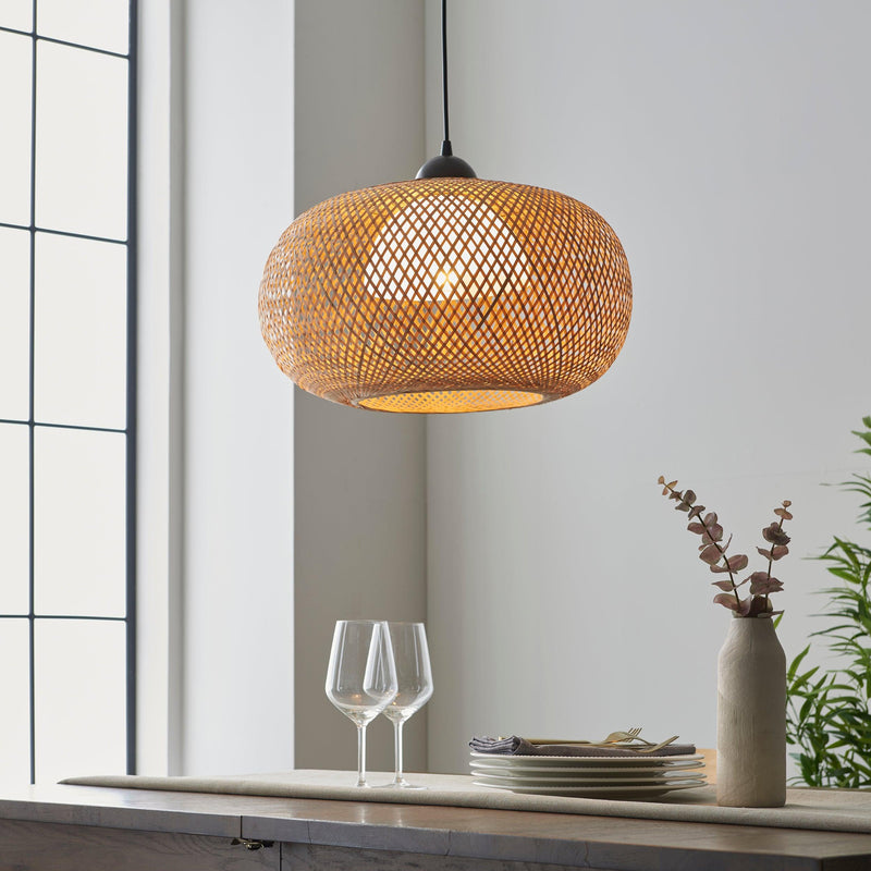 The Endon Bali 1 Light Globe Pendant features a natural bamboo and raffia twine design that forms a relaxed globe shape. Perfect for creating beach vibes, this dimmable pendant light enhances any space like the kitchen, dining room, or bedroom with its natural style and adjustable height.