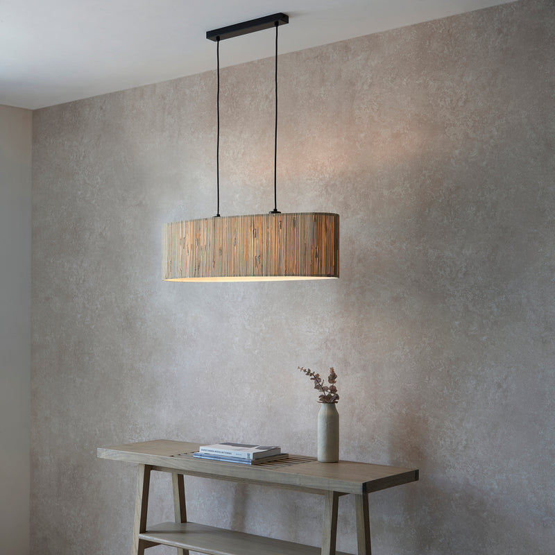 Longshore 2 Light Linear Pendant in natural seagrass and matt black shown in a room setting