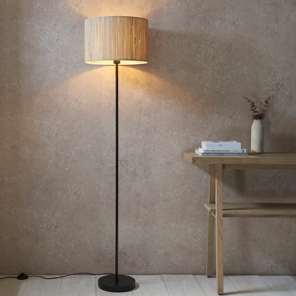 Endon Longshore Floor Lamp in natural seagrass and matt black in a styled living room