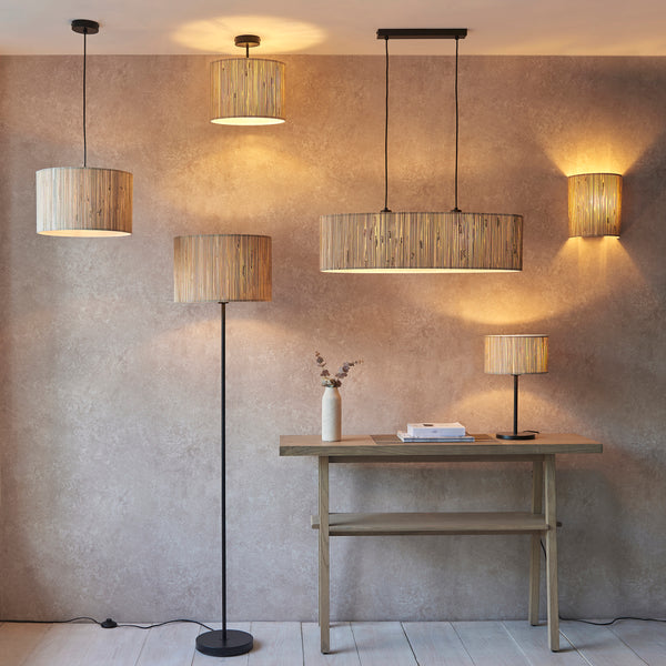 Longshore Floor Lamp lit up in a living room setting