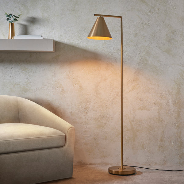 Cape Task Floor Lamp lit up in a living room setting