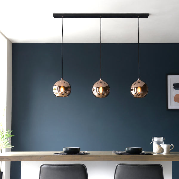Boli 3 Light Linear Pendant lit up in a styled kitchen