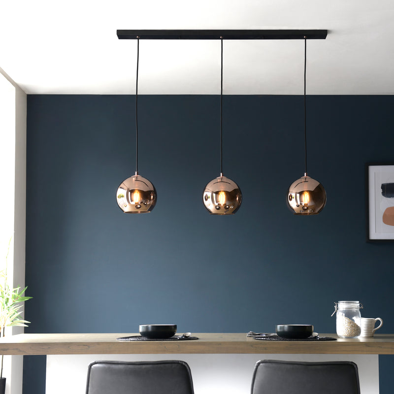 Boli 3 Light Linear Pendant lit up in a styled kitchen