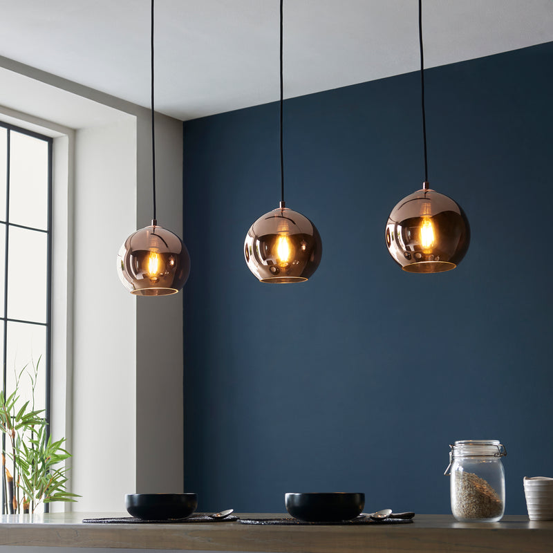 Boli 3 Light Linear Pendant in matt black and copper glass shown in a room setting