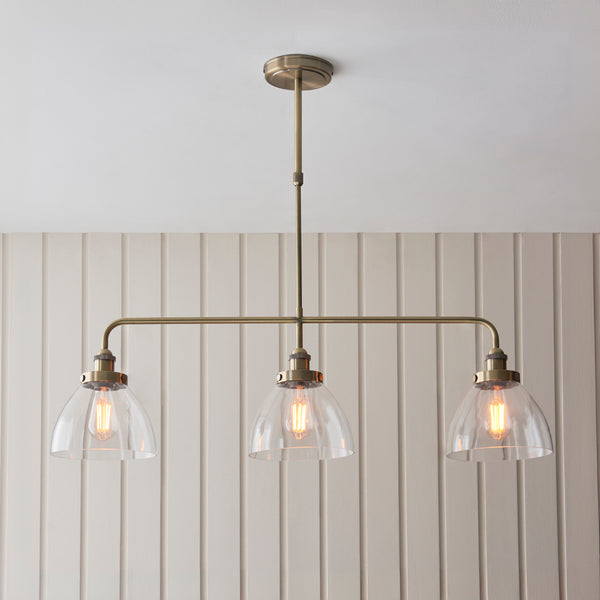 Hansen 3 Light Linear Bar Pendant lit up in a styled kitchen