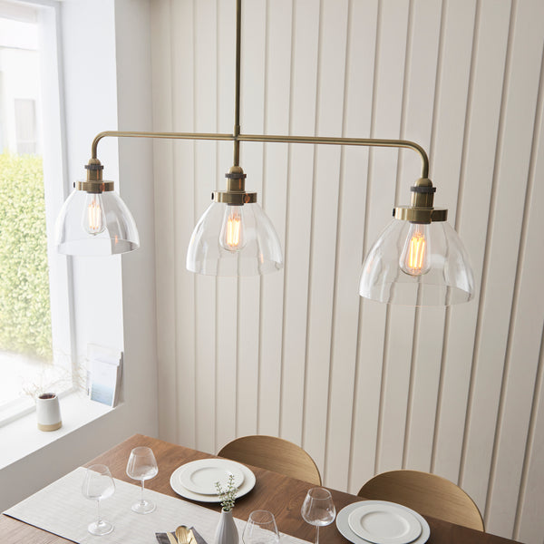 Hansen 3 Light Linear Bar Pendant in antique brass shown in a room setting