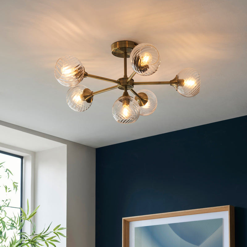 Allegra 6 Light Semi Flush Ceiling Light lit up in a styled living room