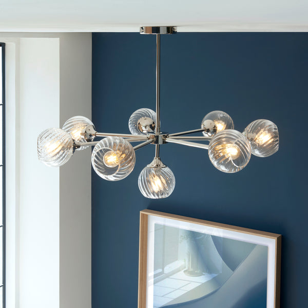 Allegra 8 Light Chandelier lit up in a styled living room