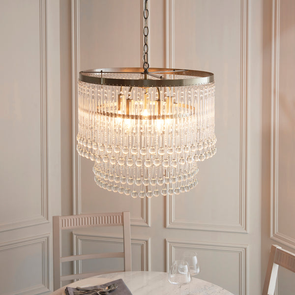 Genevieve 5 Light Chandelier lit up in a styled dining room