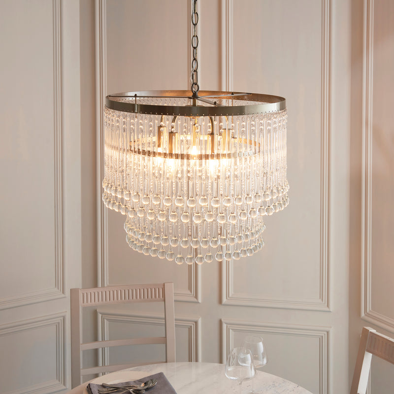 Genevieve 5 Light Chandelier lit up in a styled dining room