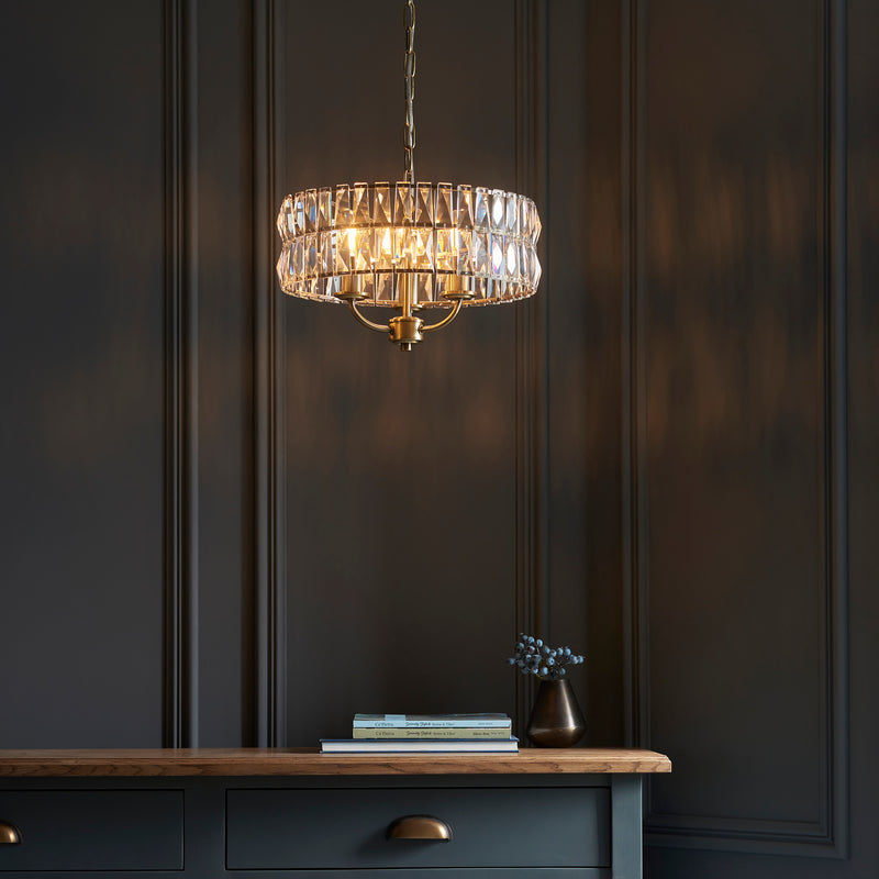 Clifton 3 Light Pendant lit up in a styled bedroom