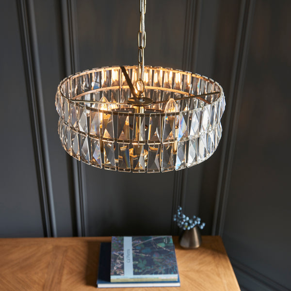 Clifton 3 Light Pendant in antique brass shown in a room setting