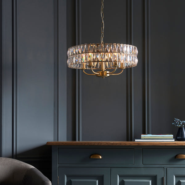 Clifton 5 Light Pendant lit up in a styled living room