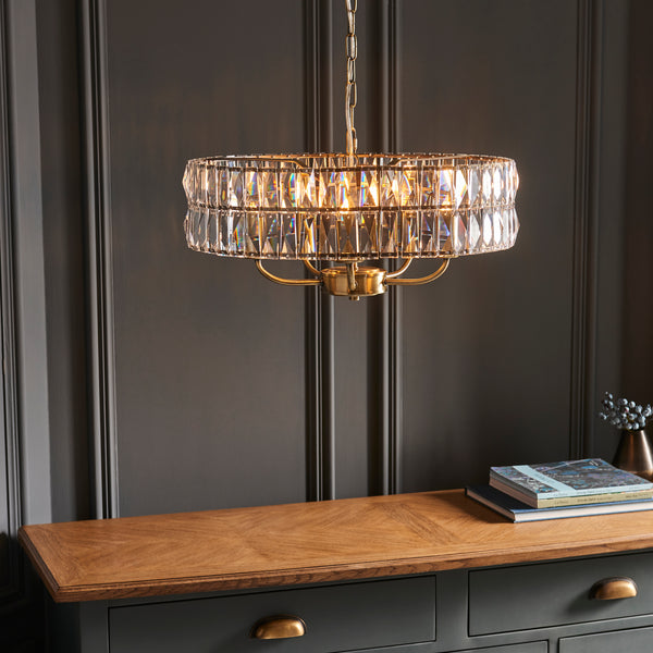 Clifton 5 Light Pendant in antique brass shown in a room setting