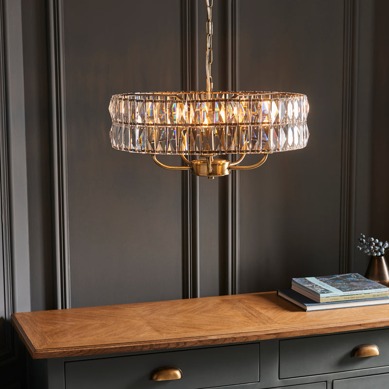 Clifton 5 Light Pendant in antique brass shown in a room setting