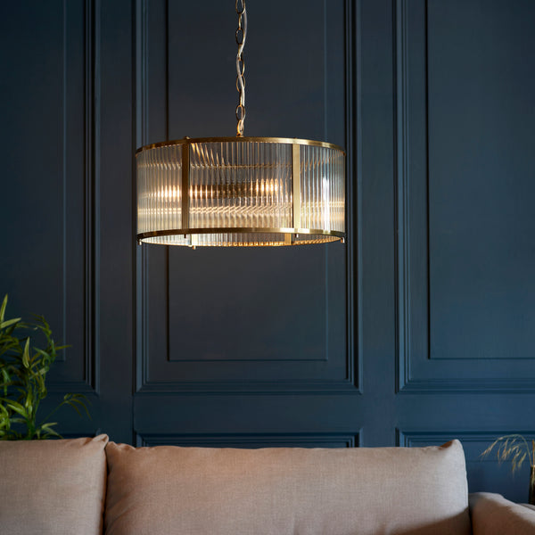 Ridgeton 3 Light Pendant in antique brass hanging in a hallway