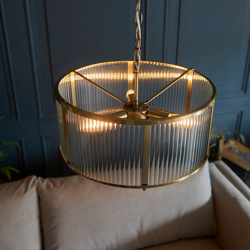 Ridgeton 3 Light Pendant in antique brass shown in a room setting
