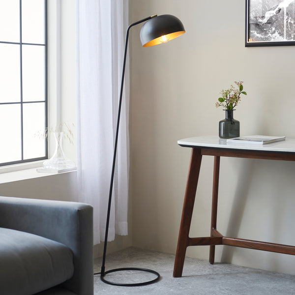 Endon Brair Task Floor Lamp in matt black and antique brass in a styled living room