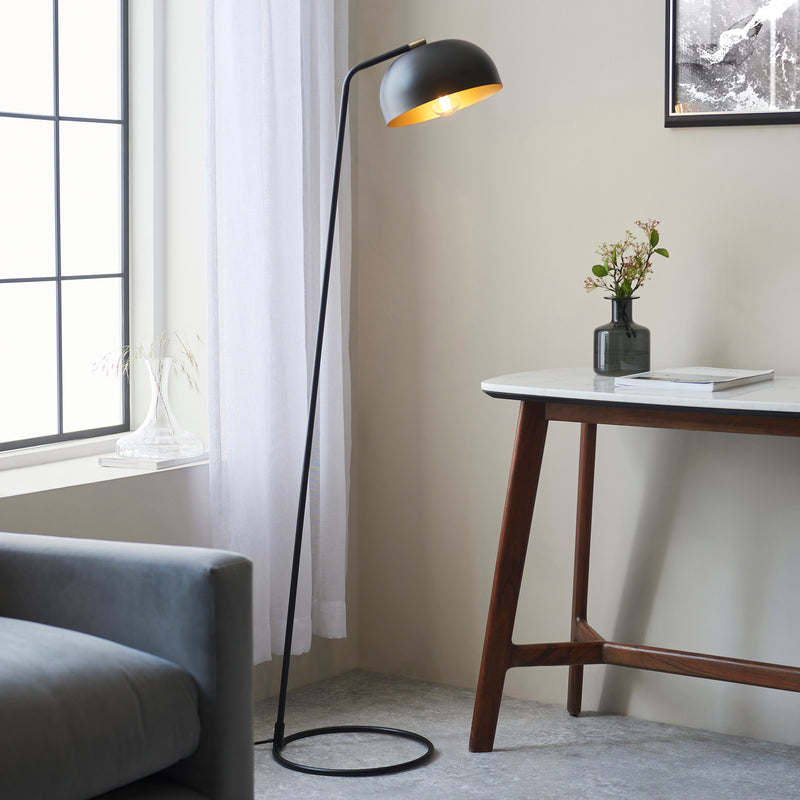 Endon Brair Task Floor Lamp in matt black and antique brass in a styled living room