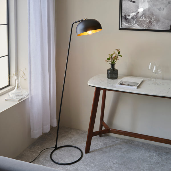 Brair Task Floor Lamp lit up in a living room setting