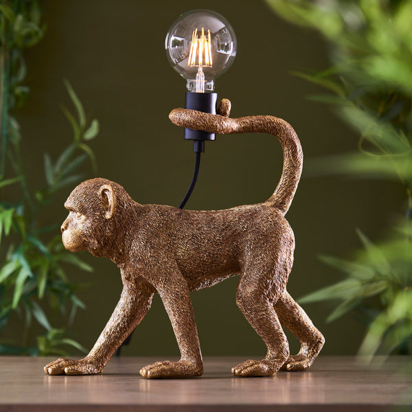 Capuchin Monkey Table Lamp lit up in a living room setting