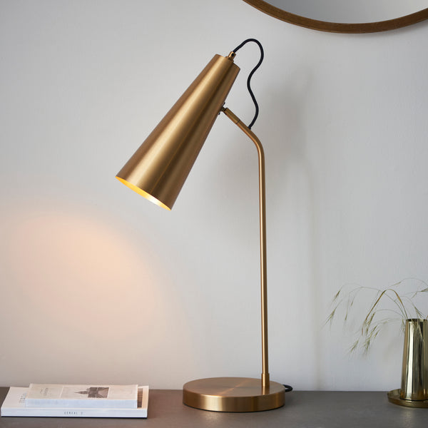 Endon Karna Task Table Lamp in warm antique brass in a styled bedroom
