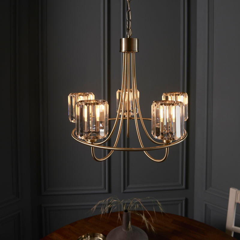 Berenice 5 Light Chandelier lit up in a styled living room