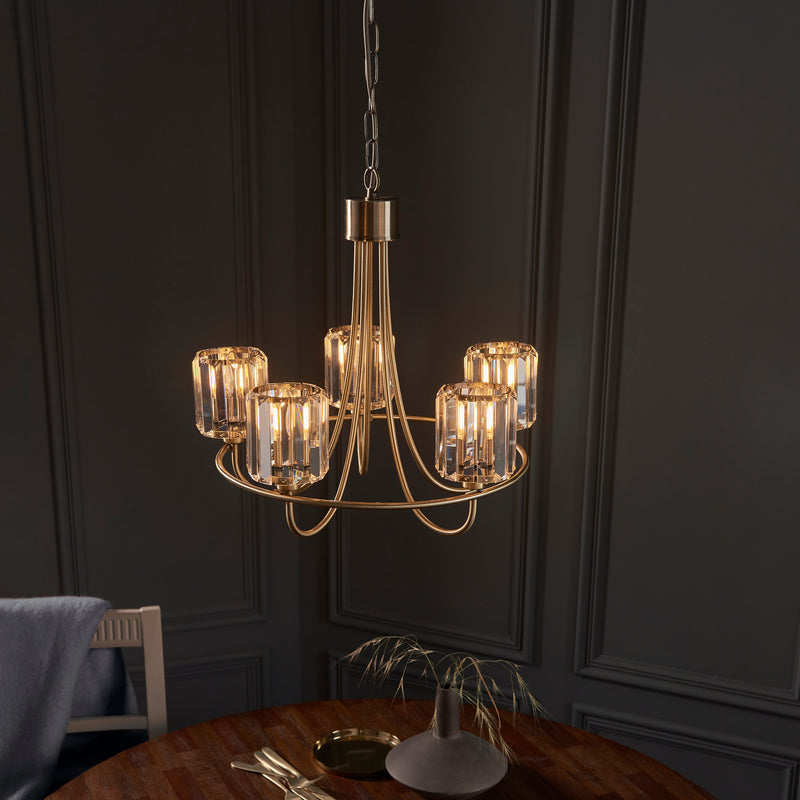 Berenice 5 Light Chandelier in antique brass shown in a room setting