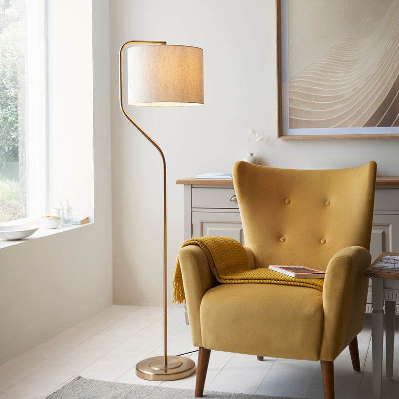 Endon Clement Floor Lamp in brushed aged brass in a styled living room