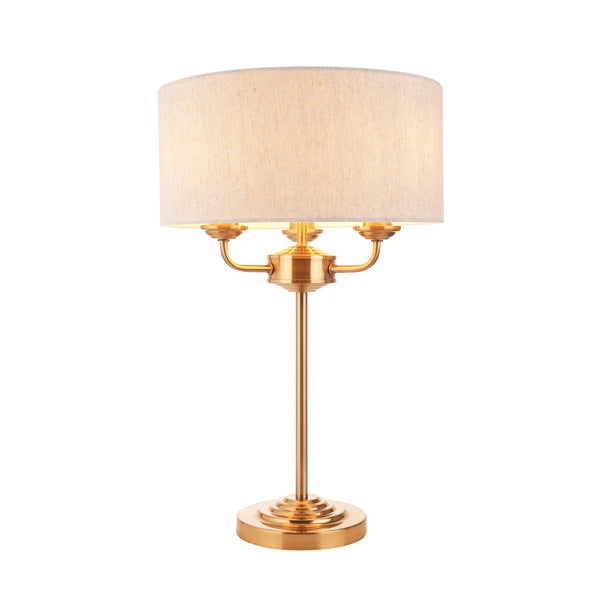 Endon Highclere 3 Light Table Lamp in vintage brass and linen on a white background