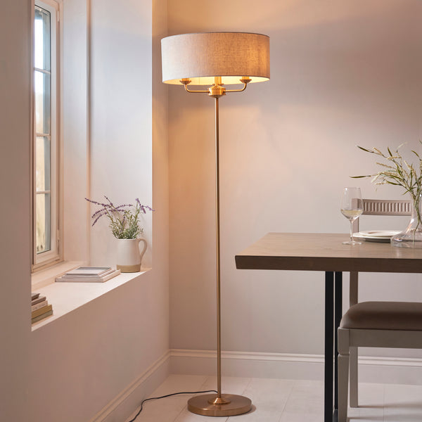 Endon Highclere 3 Light Floor Lamp in vintage brass and linen in a styled living room