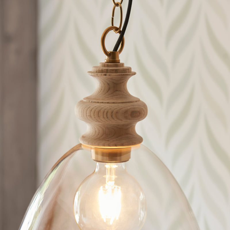 Close-up of the brushed aged brass and clear glass on the Cotswold Pendant