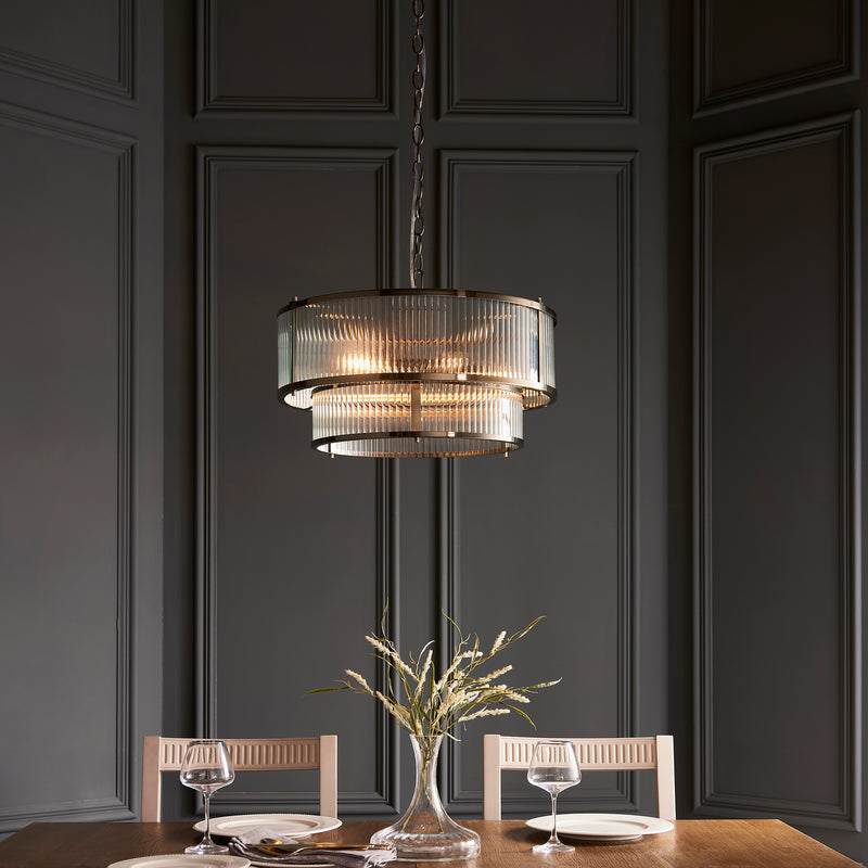 Ridgeton 5 Light Tiered Pendant in antique brass hanging in a hallway