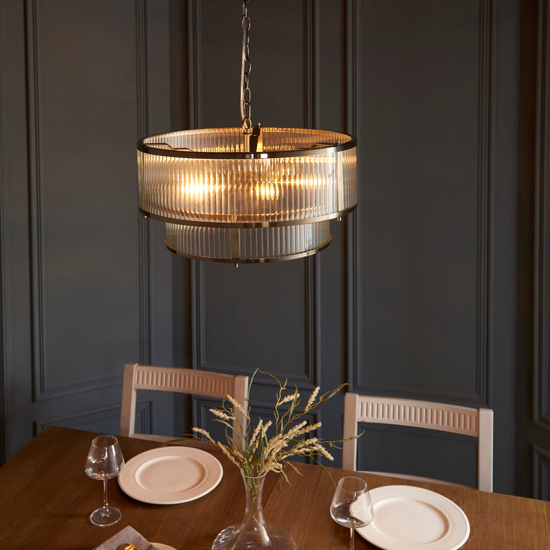 Ridgeton 5 Light Tiered Pendant lit up in a styled hallway