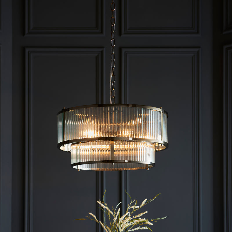 Ridgeton 5 Light Tiered Pendant in antique brass shown in a room setting