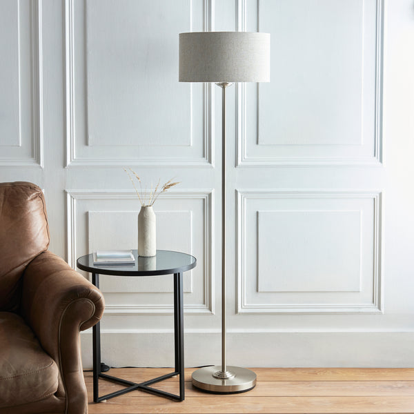 Highclere Floor Lamp lit up in a living room setting
