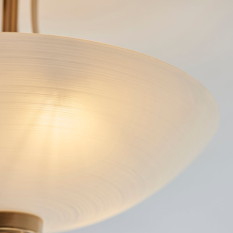 Welles 3 Light Semi Flush Ceiling Light lit up in a styled bedroom