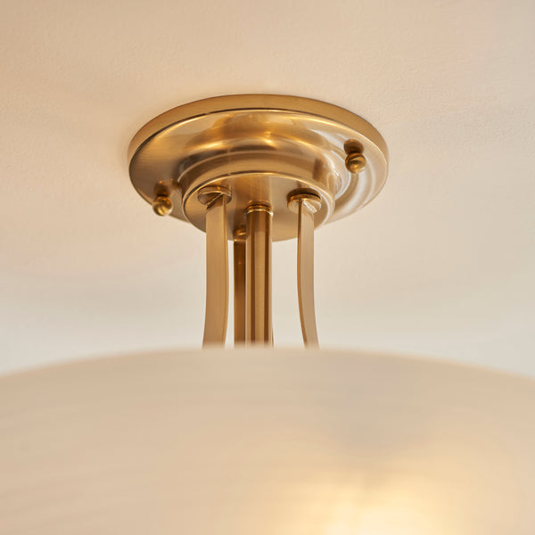 Welles 3 Light Semi Flush Ceiling Light in brushed aged brass shown in a room setting