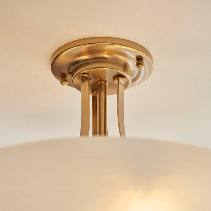 Welles 3 Light Semi Flush Ceiling Light in brushed aged brass shown in a room setting