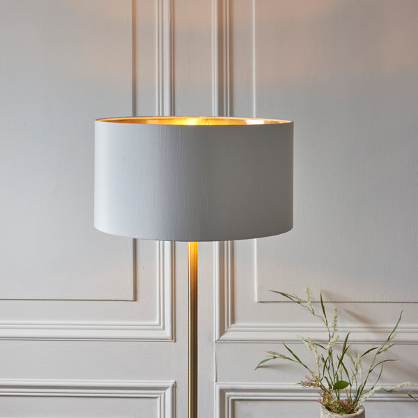 Highclere Floor Lamp lit up in a living room setting