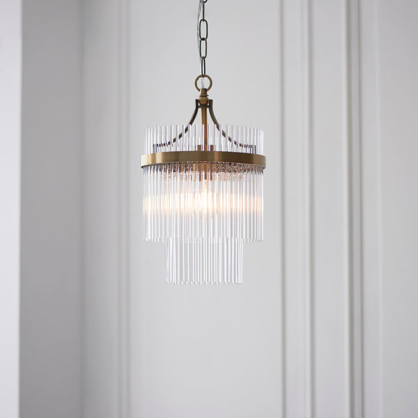 Marietta Pendant in antique brass hanging in a hallway