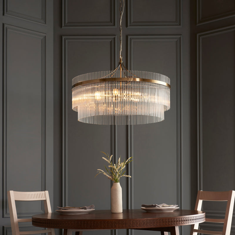 Marietta Grand 7 Light Chandelier in antique brass hanging in a dining room