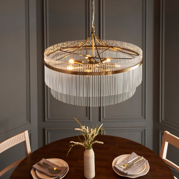 Marietta Grand 7 Light Chandelier in antique brass shown in a room setting