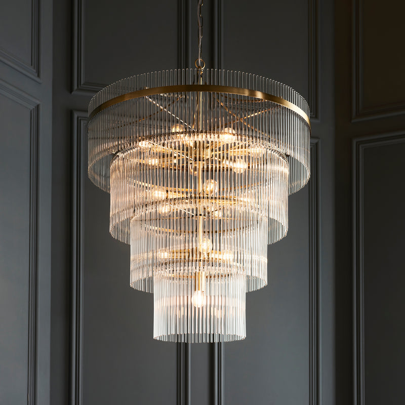 Marietta 16 Light Tiered Chandelier in antique brass hanging in a hallway