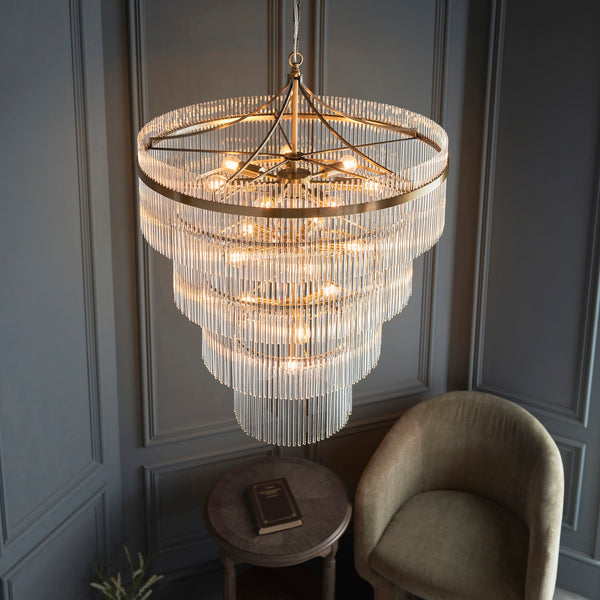 Marietta 16 Light Tiered Chandelier in antique brass shown in a room setting