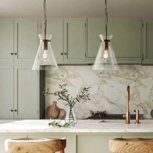Harlow Pendant in brushed aged brass hanging in a kitchen